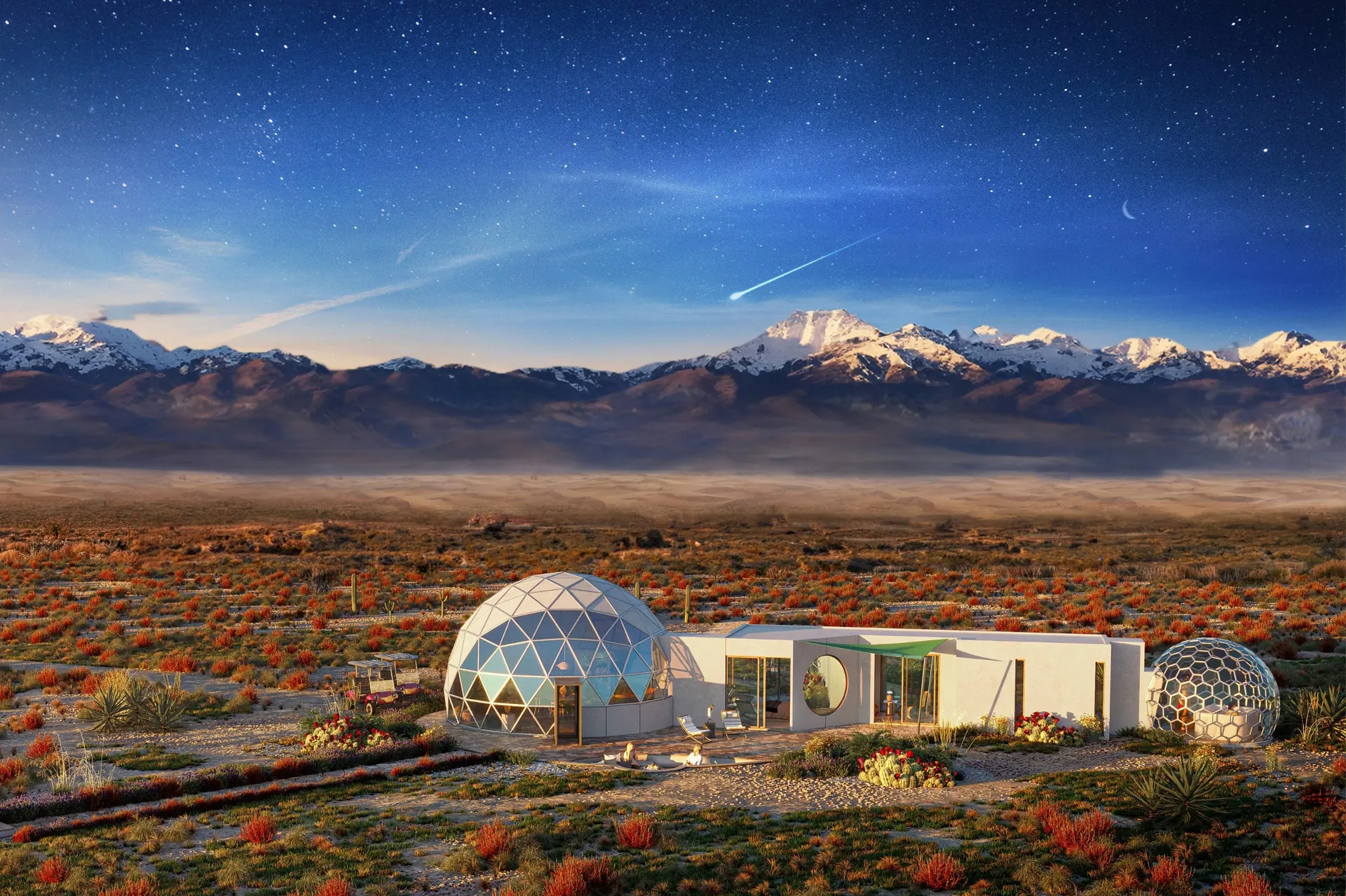 Geodesic domes and a modern lodge in the high desert at dusk, snow-capped mountains behind